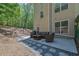 Relaxing patio featuring a seating area and a grill, perfect for entertaining guests outdoors at 1076 Firethorne Pass, Cumming, GA 30040