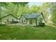 A sprawling green backyard with a sunroom, patio and lush landscaping at 2795 Autumn Dr, Canton, GA 30115