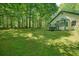 A vast backyard with mature trees surrounding the home at 2795 Autumn Dr, Canton, GA 30115