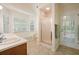 Bright bathroom featuring double sinks, a bathtub, and a separate shower stall, all illuminated by natural light at 2795 Autumn Dr, Canton, GA 30115