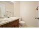 Half bathroom featuring a vanity sink and toilet with neutrally painted walls at 2795 Autumn Dr, Canton, GA 30115