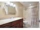 Cozy bathroom featuring a granite countertop, dark cabinets, a tub/shower with curtain and tiled floors at 2795 Autumn Dr, Canton, GA 30115