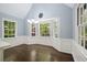 Sun-filled dining area with large bay windows offering a scenic view, complemented by elegant wainscoting at 2795 Autumn Dr, Canton, GA 30115