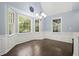 Bright dining area featuring large windows with backyard views, an elegant chandelier, and stylish wall paneling at 2795 Autumn Dr, Canton, GA 30115