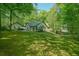 Back view of this ranch home surrounded by grass and trees at 2795 Autumn Dr, Canton, GA 30115