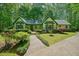 Charming home with a yellow exterior, green trim, manicured landscaping, and a welcoming walkway at 2795 Autumn Dr, Canton, GA 30115