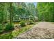 Beautiful yellow home with a green trim, surrounded by lush trees and manicured landscaping at 2795 Autumn Dr, Canton, GA 30115