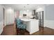 Well-lit kitchen showcasing white cabinets, a center island with seating, and stainless steel refrigerator at 2795 Autumn Dr, Canton, GA 30115