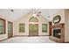 Bright living room with stone fireplace, vaulted ceilings, and french doors leading to the exterior at 2795 Autumn Dr, Canton, GA 30115