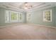 Spacious main bedroom featuring tray ceilings, a ceiling fan, and plenty of natural light at 2795 Autumn Dr, Canton, GA 30115