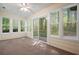 Bright sunroom with wall-to-wall carpeting and sliding doors and windows that provide views of the outdoors at 2795 Autumn Dr, Canton, GA 30115