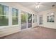 Bright sunroom featuring large windows showcasing beautiful wooded views and sliding glass door to outside at 2795 Autumn Dr, Canton, GA 30115