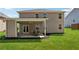 Back of the home featuring a covered patio with dining set, a ceiling fan and a lush green lawn at 4050 Danbury Farms Dr, Cumming, GA 30040