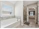 Relaxing bathroom with a soaking tub, glass shower, and neutral tones at 4050 Danbury Farms Dr, Cumming, GA 30040