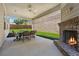 Inviting covered patio with a fireplace and comfortable seating, perfect for relaxing outdoors at 4050 Danbury Farms Dr, Cumming, GA 30040