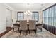 Formal dining room with elegant curtains, stylish lighting, and comfortable seating for six at 4050 Danbury Farms Dr, Cumming, GA 30040