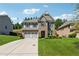 Attractive two-story home boasting brick accents, light gray siding, a spacious driveway, and manicured landscaping at 4050 Danbury Farms Dr, Cumming, GA 30040
