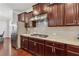 Gourmet kitchen featuring dark wood cabinets, stainless steel appliances, and granite countertops at 4050 Danbury Farms Dr, Cumming, GA 30040