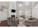 Inviting living room with a cozy fireplace, high ceilings, and comfortable seating arrangement at 4050 Danbury Farms Dr, Cumming, GA 30040