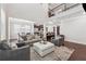 Bright and airy living room with hardwood floors, plush seating, and an open floor plan at 4050 Danbury Farms Dr, Cumming, GA 30040