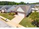 Aerial view showcasing the home's landscaping, driveway, and two-car garage at 806 Village Pl, Loganville, GA 30052