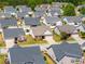 Aerial view showcases a suburban neighborhood with well-maintained homes and lush green lawns at 806 Village Pl, Loganville, GA 30052