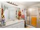Bright bathroom featuring a single sink vanity and a sliding glass door shower at 806 Village Pl, Loganville, GA 30052
