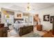 Comfortable bedroom with tray ceiling, wood accents, and a view to the bright, full bathroom at 806 Village Pl, Loganville, GA 30052