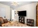 Inviting Bonus room provides flexibility for use as a den with custom shelving, a place to relax and unwind at 806 Village Pl, Loganville, GA 30052