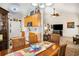 Cozy dining area featuring a wooden table with four chairs, open to the kitchen and living room, creating a warm and inviting space at 806 Village Pl, Loganville, GA 30052
