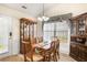 Cozy dining room with a wooden table, decorative cabinets, and natural light at 806 Village Pl, Loganville, GA 30052