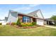 Well-maintained home exterior with a brick facade, shuttered windows, and manicured landscaping at 806 Village Pl, Loganville, GA 30052