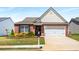 Charming brick home with manicured lawn and attached two-car garage at 806 Village Pl, Loganville, GA 30052