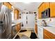 Charming kitchen boasting stainless steel appliances, wood cabinets, white countertops, and neutral flooring for a classic touch at 806 Village Pl, Loganville, GA 30052