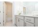 Clean, white bathroom featuring modern vanity, neutral countertops, and tile flooring at 113 Iveybrooke Ln # 61, Alpharetta, GA 30009