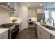 Beautiful kitchen with stainless steel appliances, grey cabinets, and quartz countertops at 113 Iveybrooke Ln # 61, Alpharetta, GA 30009