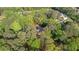 A serene aerial perspective of a property embraced by vibrant, mature trees at 130 Laguna Springs Dr, Woodstock, GA 30188