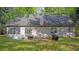 Exterior back of home with lush green grass and patio at 130 Laguna Springs Dr, Woodstock, GA 30188
