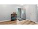 Bright entryway with hardwood floors, complemented by gray walls, front door and featuring a decorative cabinet at 130 Laguna Springs Dr, Woodstock, GA 30188