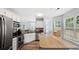Bright kitchen features stainless steel appliances, breakfast bar, and plenty of cabinet space at 130 Laguna Springs Dr, Woodstock, GA 30188