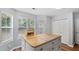 Kitchen island with cabinets and seating at 130 Laguna Springs Dr, Woodstock, GA 30188