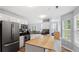 Bright kitchen features stainless steel appliances, center island, and plenty of cabinet storage space at 130 Laguna Springs Dr, Woodstock, GA 30188