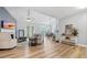 Open-concept living room with hardwood floors, vaulted ceiling, fireplace and lots of natural light from big windows at 130 Laguna Springs Dr, Woodstock, GA 30188