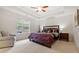Bright main bedroom features a tray ceiling, large window, and neutral carpet at 130 Laguna Springs Dr, Woodstock, GA 30188