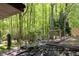 Serene backyard retreat featuring a fire pit, wooden swings, and lush greenery, perfect for enjoying nature at 247 Shallowford Nw Rd, Kennesaw, GA 30144