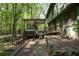 Expansive backyard with a covered patio, hot tub, and verdant landscape, designed for outdoor entertainment and relaxation at 247 Shallowford Nw Rd, Kennesaw, GA 30144
