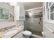 Bathroom featuring a glass-enclosed shower, granite countertops, and a window with natural light at 247 Shallowford Nw Rd, Kennesaw, GA 30144