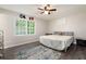 Comfortable bedroom with a ceiling fan, view of the outdoors, and neutral decor at 247 Shallowford Nw Rd, Kennesaw, GA 30144
