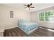 Cozy bedroom with a ceiling fan, a large window providing natural light, and neutral-colored walls at 247 Shallowford Nw Rd, Kennesaw, GA 30144