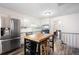 Well-lit kitchen with stainless steel appliances, a butcher block island, and subway tile backsplash at 247 Shallowford Nw Rd, Kennesaw, GA 30144